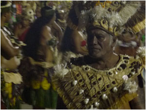 A village elder leads his dancers to the floor